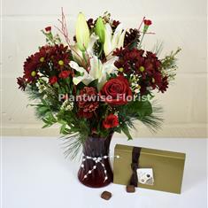A Christmas Spice Vase of Flowers With Chocolates
